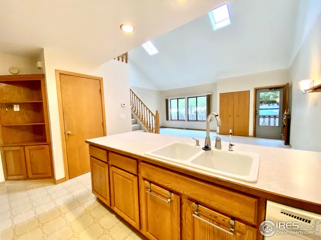 a spacious bathroom with a granite countertop sink and a mirror