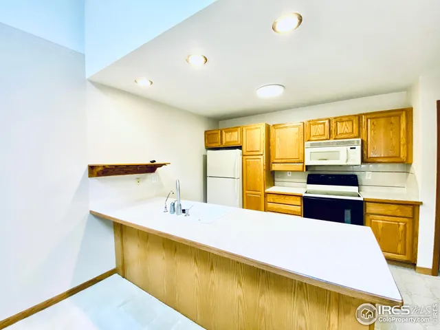 a bathroom with a tub a sink and a large window
