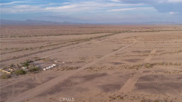a view of ocean beach and mountain