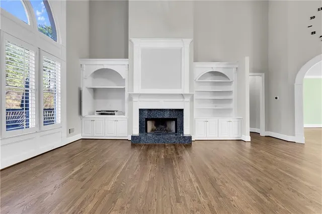 a view of an empty room window and wooden floor