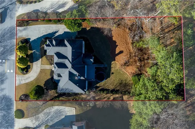 an empty room with wooden floor fireplace and cabinet