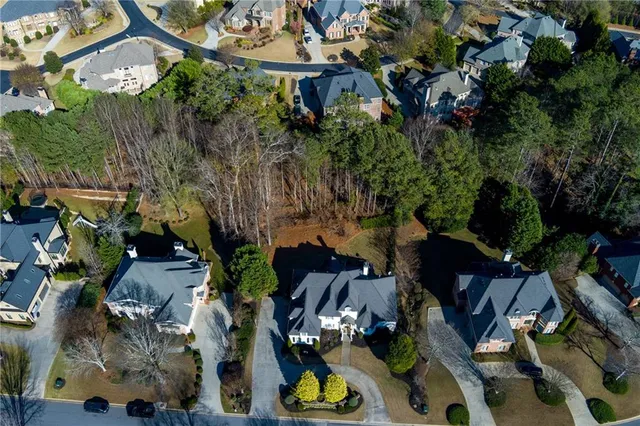a kitchen with stainless steel appliances granite countertop a sink a stove and a wooden floors
