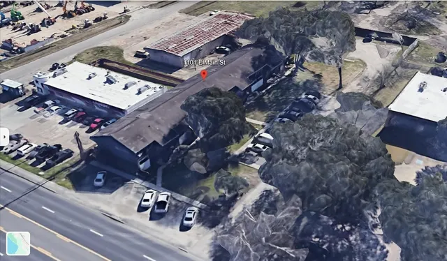 an aerial view of a house with a yard
