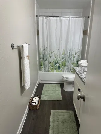 a kitchen with a refrigerator and white cabinets