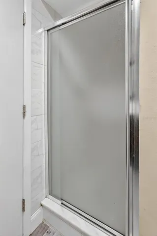 a bedroom with a bed and a potted plant on dresser