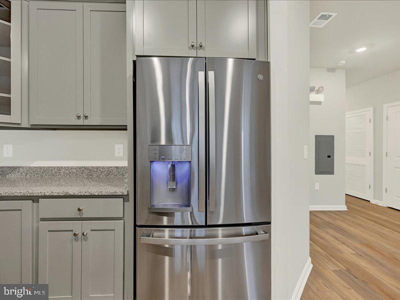 4003 Seaside Alder Road, Unit 102 ASTER Bowie, MD 20720 - Photo 12 of 27 a kitchen with stainless steel appliances granite countertop a refrigerator and a sink