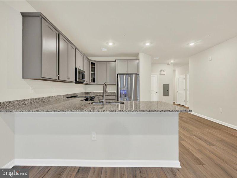 4003 Seaside Alder Road, Unit 102 ASTER Bowie, MD 20720 - Photo 14 of 27 a large kitchen with granite countertop a large counter top stainless steel appliances and cabinets