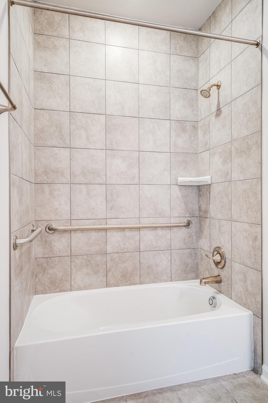 4003 Seaside Alder Road, Unit 102 ASTER Bowie, MD 20720 - Photo 15 of 16 a bathroom with a bathtub and shower
