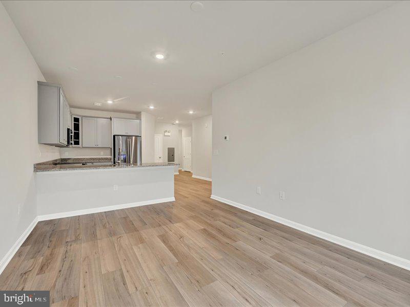 4003 Seaside Alder Road, Unit 102 ASTER Bowie, MD 20720 - Photo 16 of 27 a view of kitchen with wooden floor