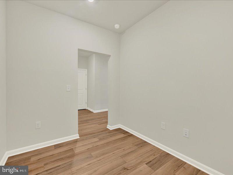 4003 Seaside Alder Road, Unit 102 ASTER Bowie, MD 20720 - Photo 20 of 27 a view of wooden floor and windows in a room