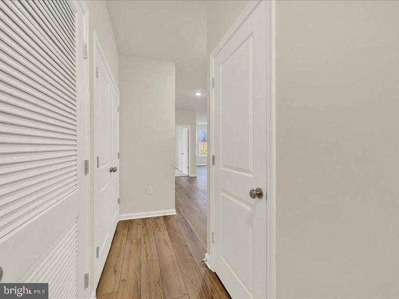 4003 Seaside Alder Road, Unit 102 ASTER Bowie, MD 20720 - Photo 2 of 27 a view of a hallway with wooden floor