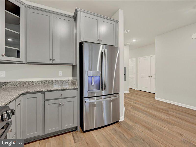4003 Seaside Alder Road, Unit 102 ASTER Bowie, MD 20720 - Photo 7 of 27 a kitchen with granite countertop a refrigerator and a sink