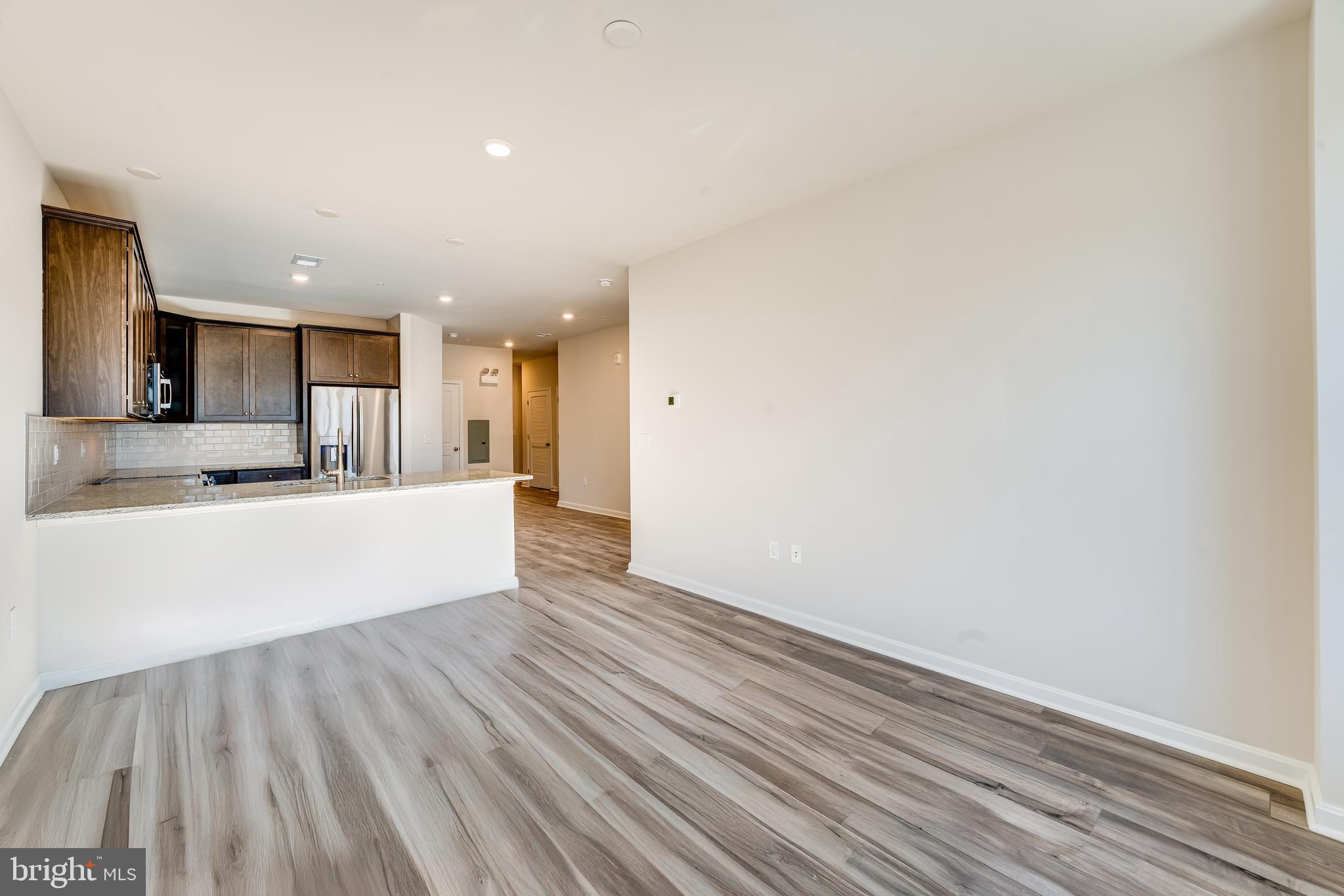 4003 Seaside Alder Road, Unit 102 ASTER Bowie, MD 20720 - Photo 8 of 16 a view of kitchen with wooden floor