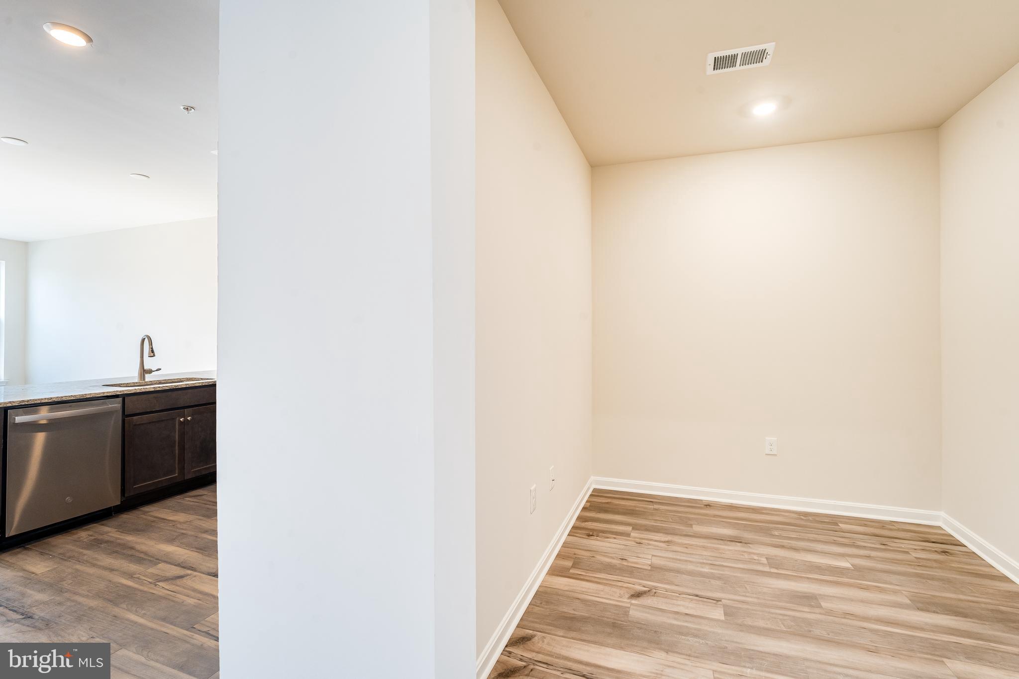 4003 Seaside Alder Road, Unit 102 ASTER Bowie, MD 20720 - Photo 9 of 16 a view of a kitchen from the hallway