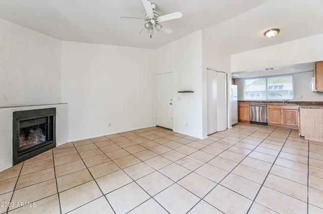 a view of a kitchen with a sink and a fireplace in a room