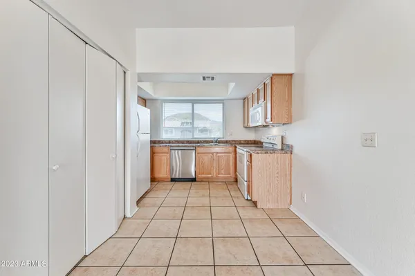 a view of a kitchen with white cabinets