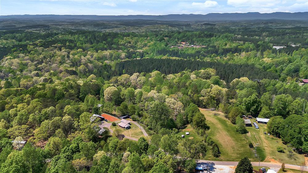 120 Collins Road Salem, SC 29676 - Photo 3 of 10 A sprawling rural landscape offers a secluded retreat amidst mature trees and open fields.
