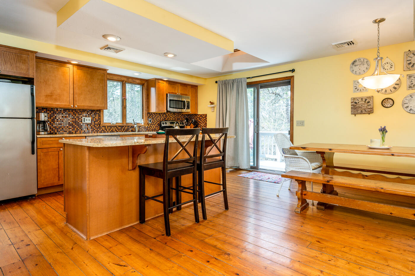 150 Herring Brook Road Eastham, MA 02642 - Photo 12 of 54 a view of a dining room with furniture and wooden floor