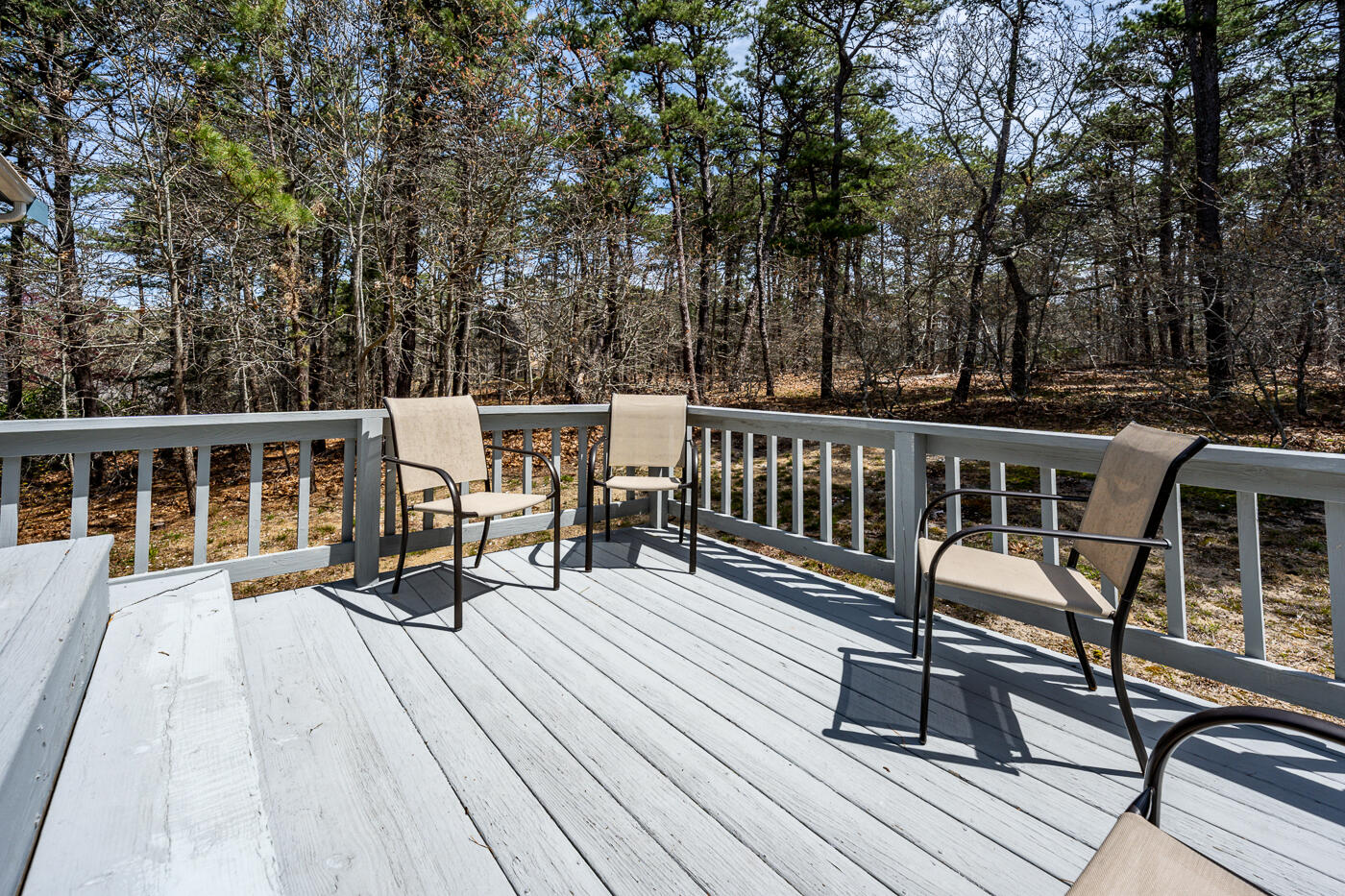 150 Herring Brook Road Eastham, MA 02642 - Photo 38 of 54 a view of a house with wooden deck and furniture