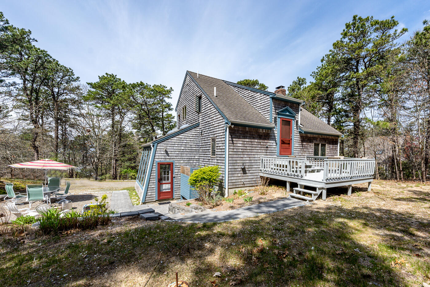 150 Herring Brook Road Eastham, MA 02642 - Photo 8 of 54 a backyard of a house with table and chairs