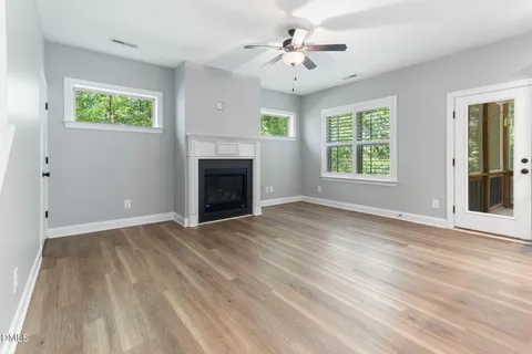 a view of kitchen with stainless steel appliances granite countertop a stove top oven a refrigerator a sink and dishwasher with wooden floor