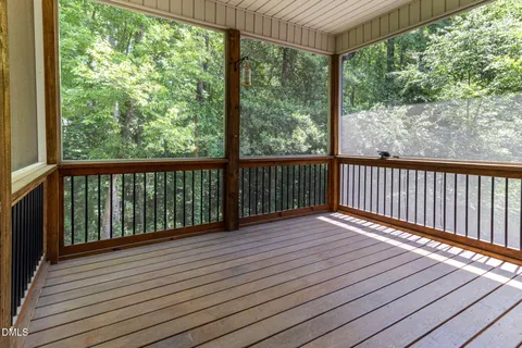 a view of a kitchen with white cabinets and wooden floor
