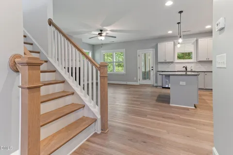 a kitchen with stainless steel appliances granite countertop a refrigerator a stove and a wooden floors