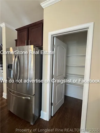 a kitchen with granite countertop lots of wooden cabinets