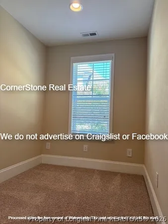 en empty room with windows and ceiling fan