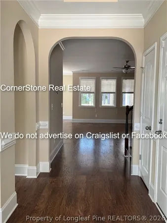 a view of a living room and hallway with wooden floor