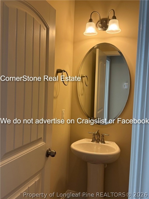 547 Micahs Way North Spring Lake, NC 28390 - Photo 9 of 28 a bathroom with a sink and mirror