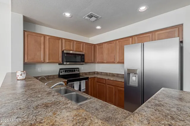 a view of empty room with wooden floor and ceiling fan