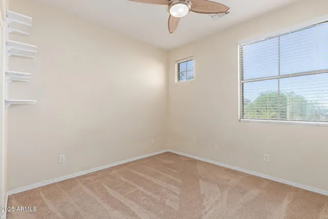 a view of a big room with closet and fan