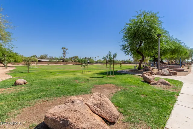 a view of a patio with table and chairs and potted plants
