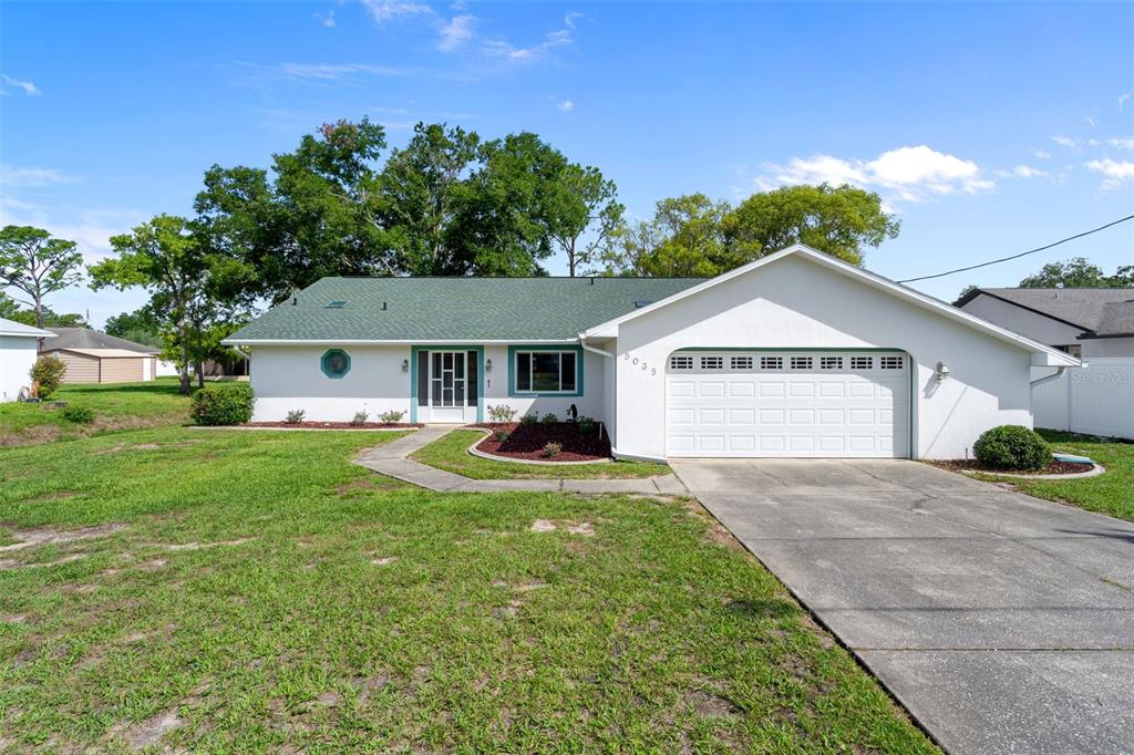 5035 Harbinger Road Spring Hill, FL 34608 - Photo 1 of 47 a view of a house with a yard