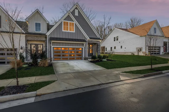 a front view of a house with a yard and garage