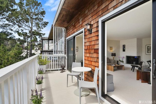 a view of a balcony with chairs