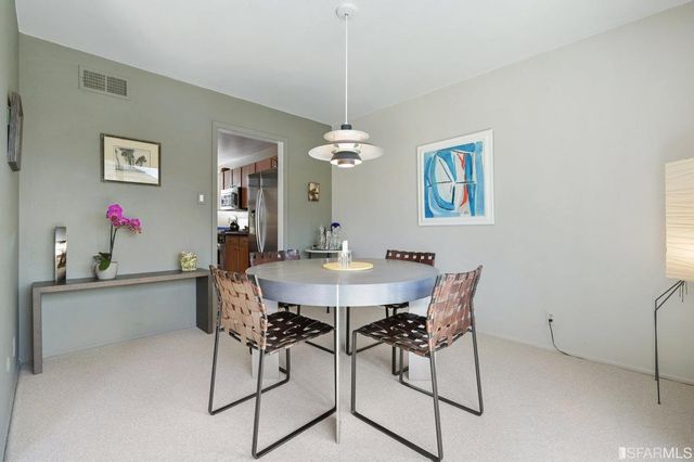 a view of a dining room with furniture and chandelier