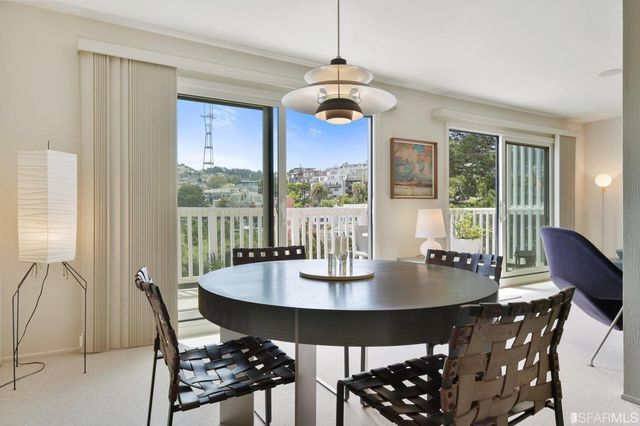 a view of a dining room with furniture window and outside view