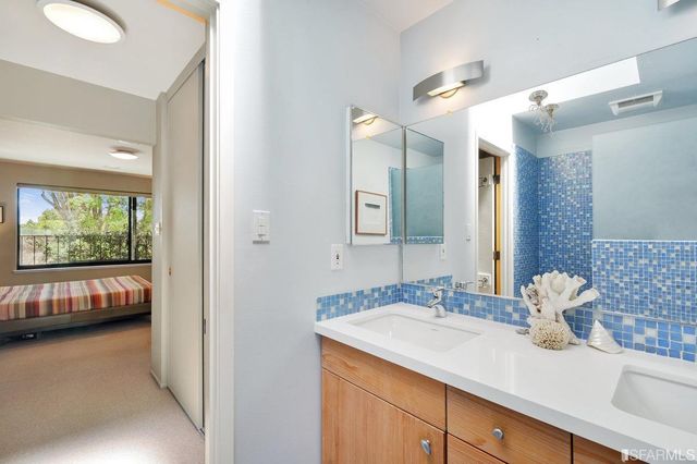 a en suite bathroom with a sink and a mirror