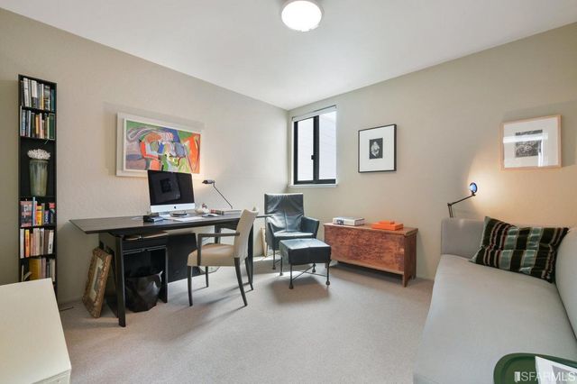 a view of a livingroom with workspace and a couch