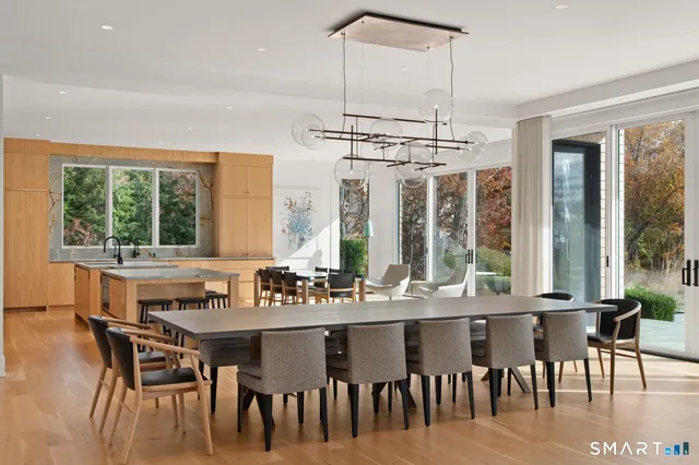 a dining table with chairs and window