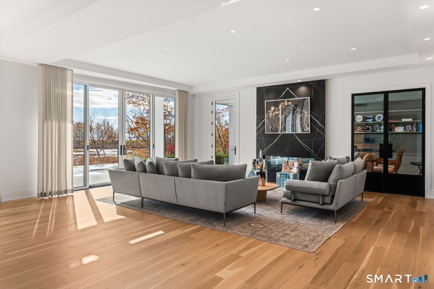 19 Beachside Common Westport, CT 06880 - Photo 13 of 40 a living room with furniture and a large window