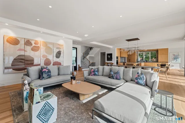 a living room with furniture and a lamp