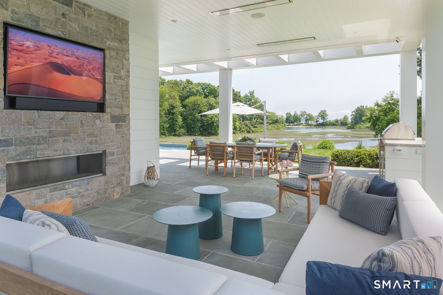 19 Beachside Common Westport, CT 06880 - Photo 16 of 40 a living room with patio furniture and a fireplace