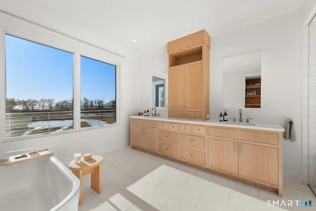 a spacious bathroom with a double vanity sink and a large mirror