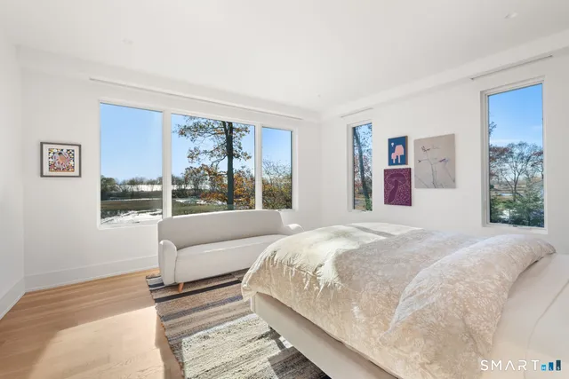 a bedroom with a large bed and a large window