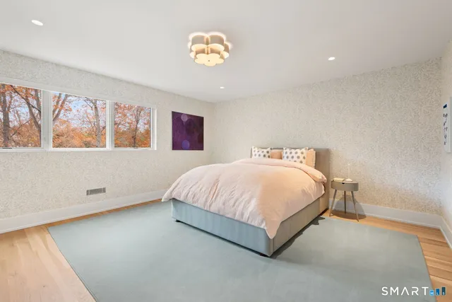 a spacious bedroom with a bed and a window