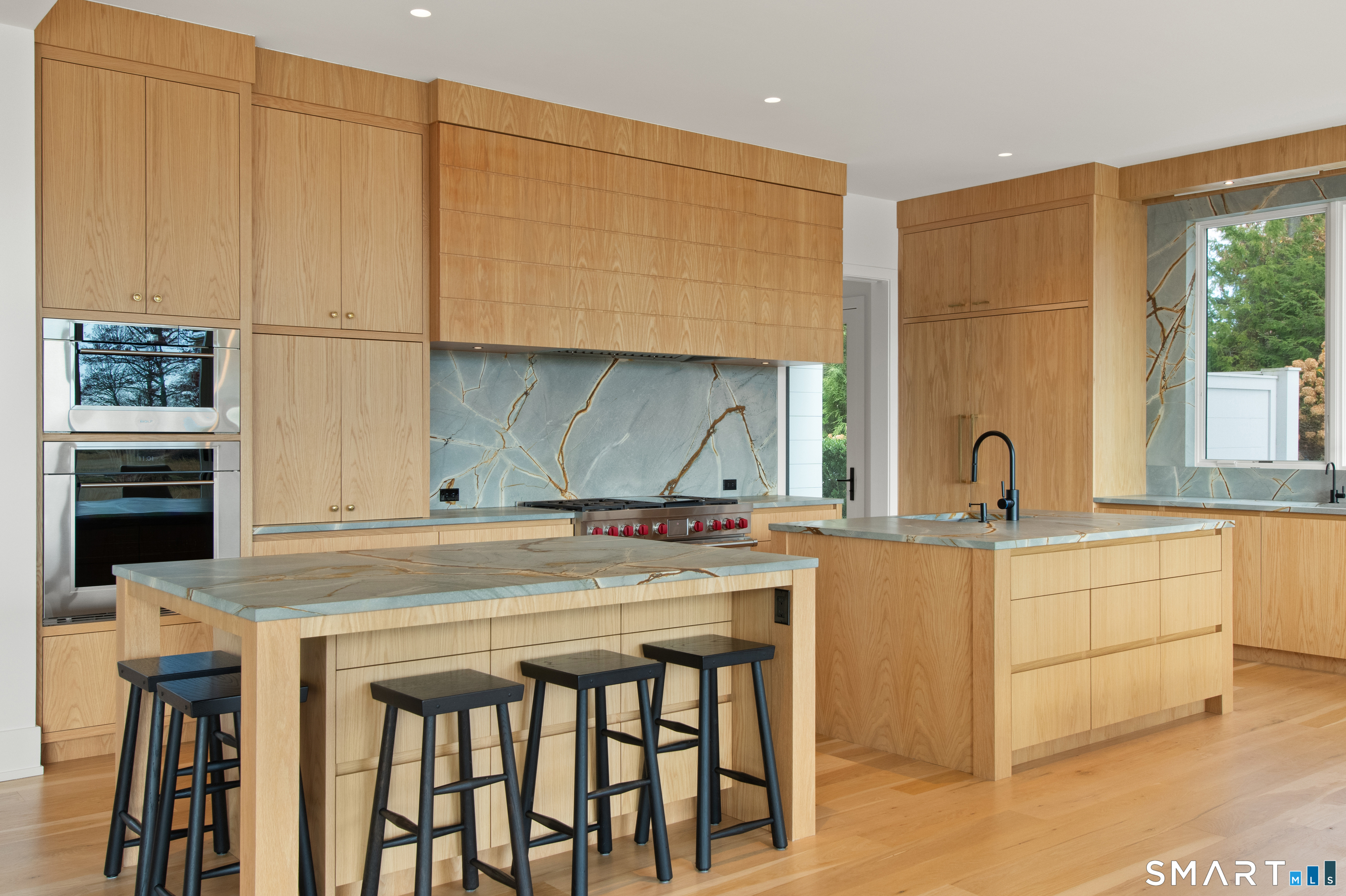 19 Beachside Common Westport, CT 06880 - Photo 6 of 40 a kitchen with stainless steel appliances granite countertop a stove a sink and a microwave