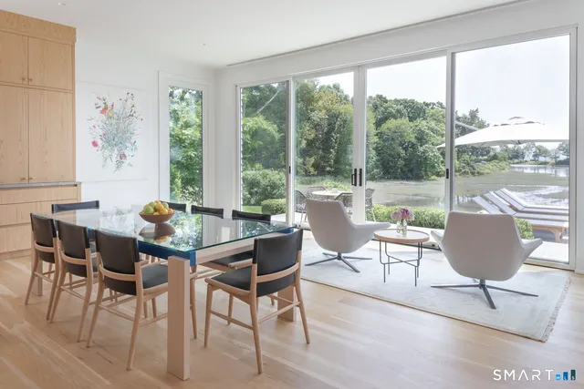 a dining room with furniture a rug and wooden floor